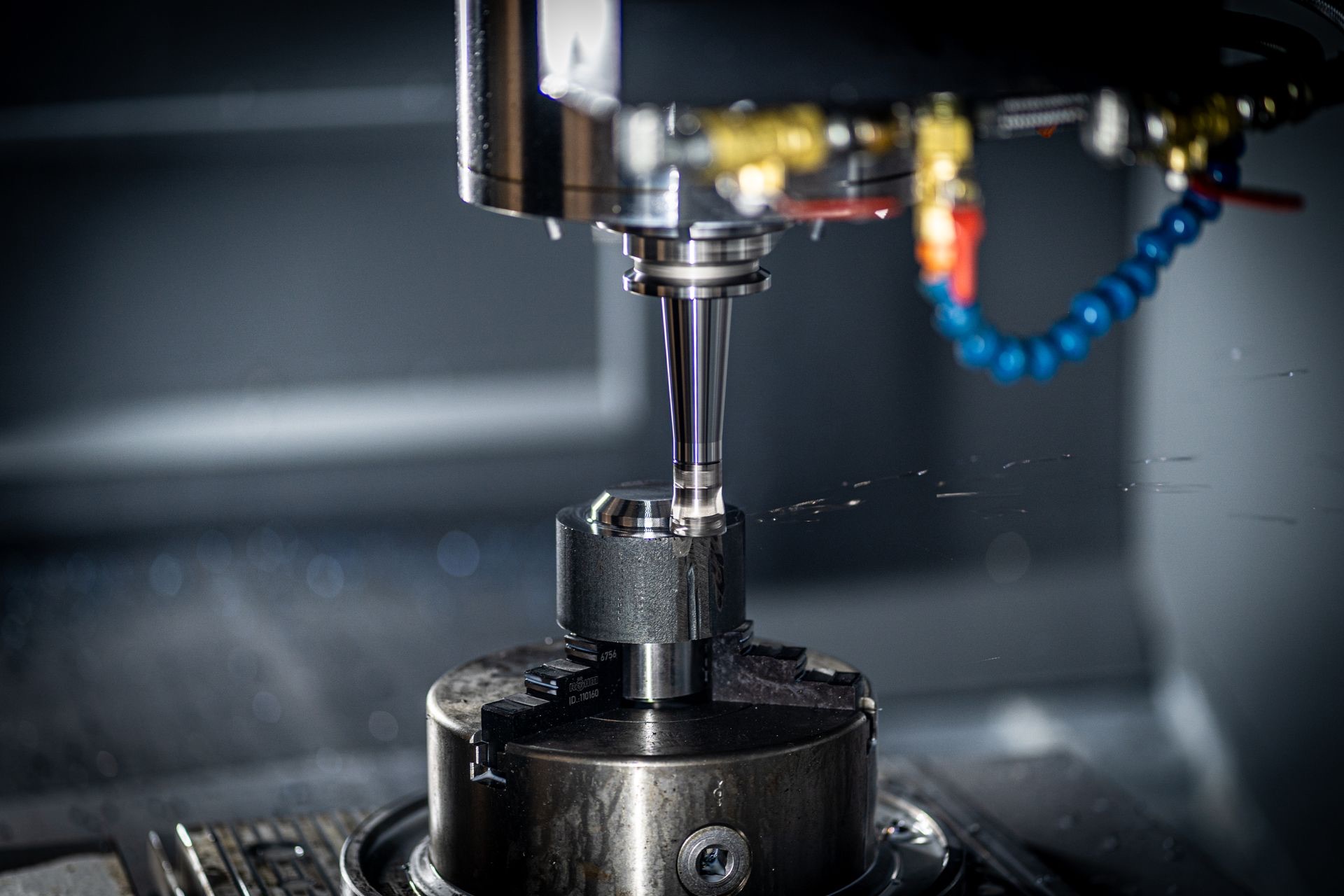 5-axis CNC machine precision machining a steel instrumentation component at Best Machine Inc. in New Hampshire